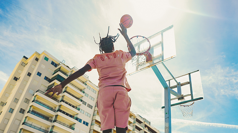 man putting ball in the basket