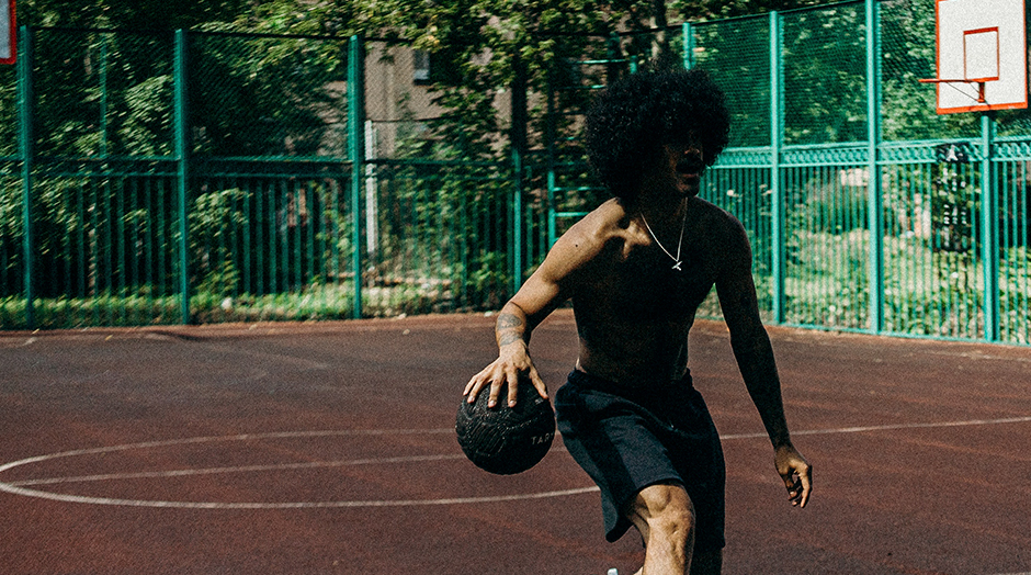 man dribbling basketball